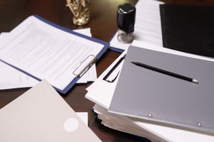 stack-of-juridical-documents-in-folders-and-clipbo-2025-03-16-15-07-17-utc (1)